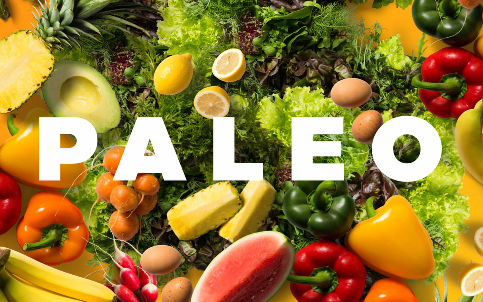 the word Paleo on a background of various fruits and vegetables
