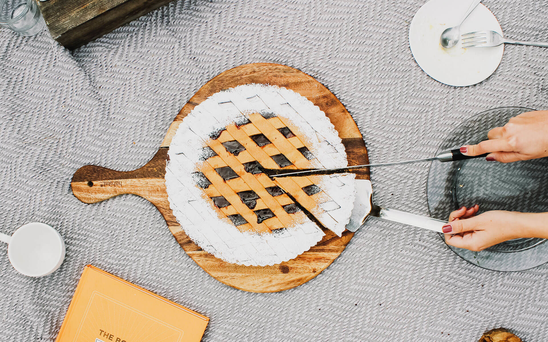 closeup of someone cutting into a blueberry pie