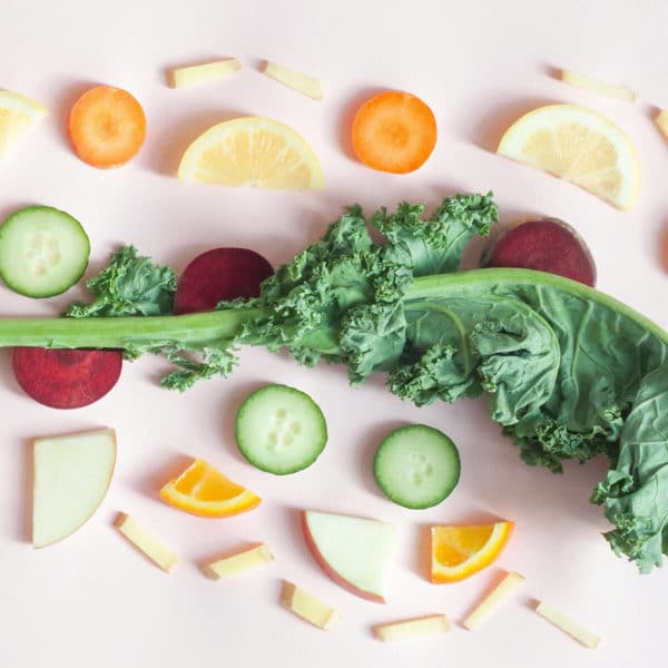 citrus fruits arranged around a piece of kale