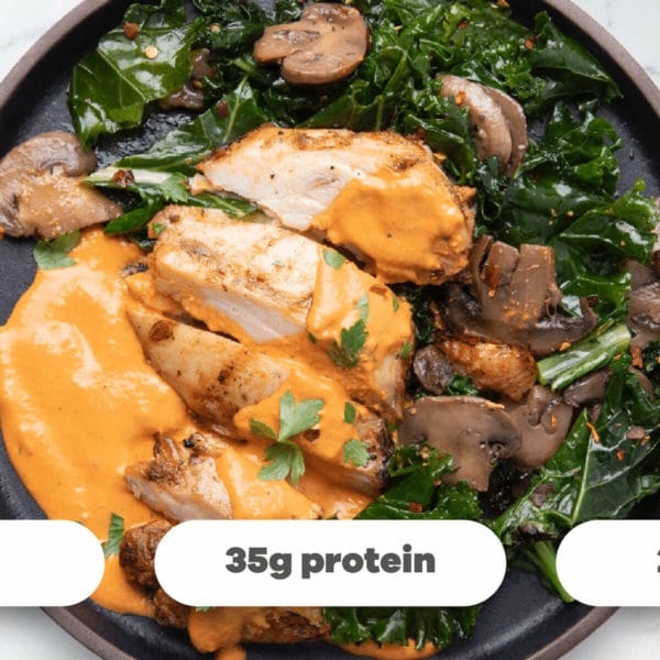 plate of chicken with mushrooms, greens and a creamy sauce with nutrition labels