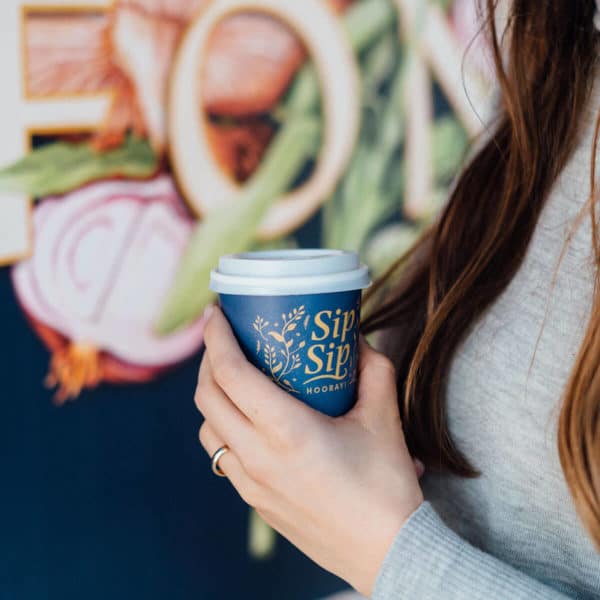 closeup of someone holding a cup of coffee in their hands