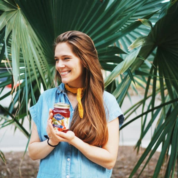 Alysa Seeland holding a jar of bone broth from her company