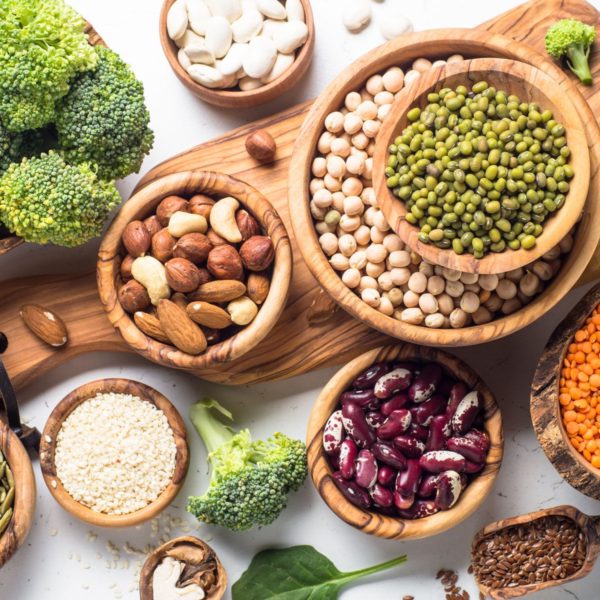 Beans, nuts and veggies spread out on trays and bowls