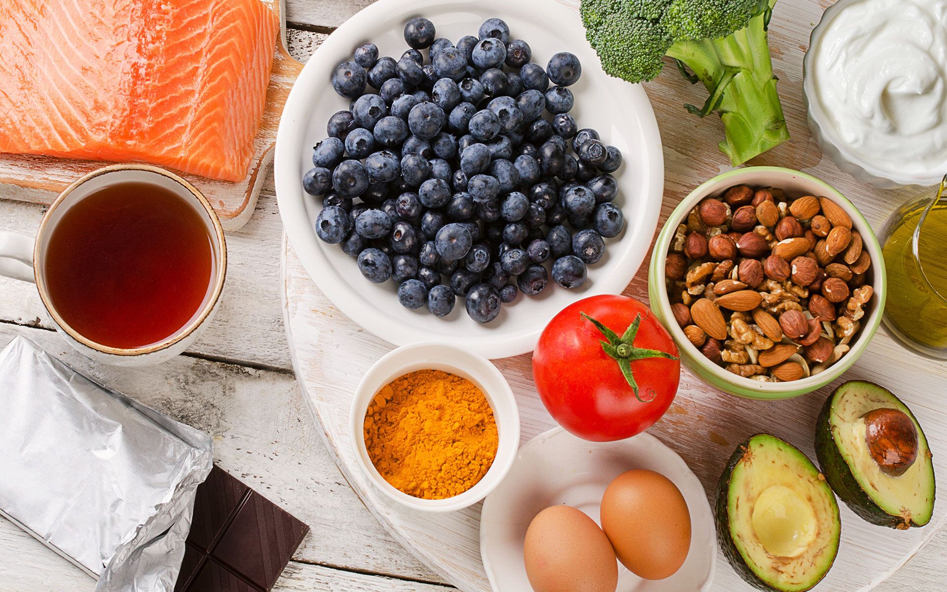 spread of salmon, blueberries, avocado, eggs and sauces on a table