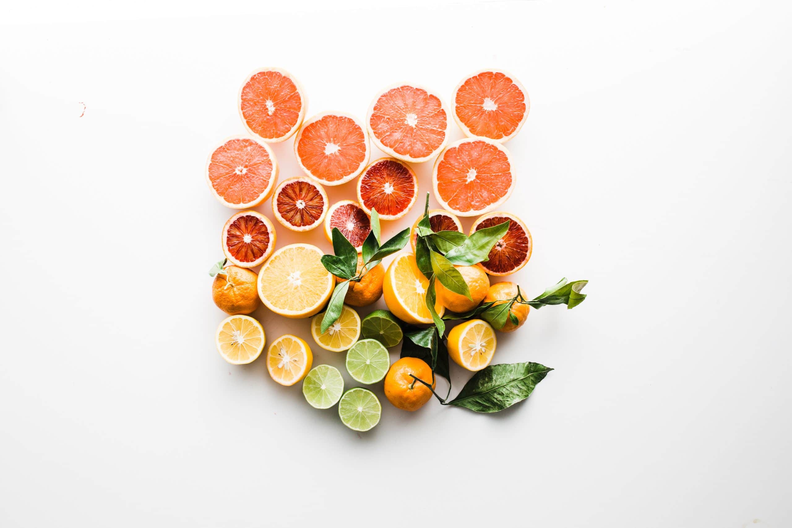 grapefruit, oranges and limes on a light background