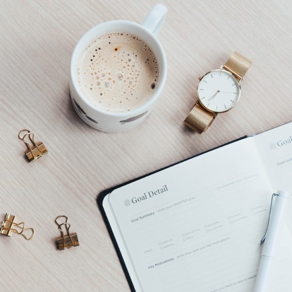 Close up of a planner and a cup of tea