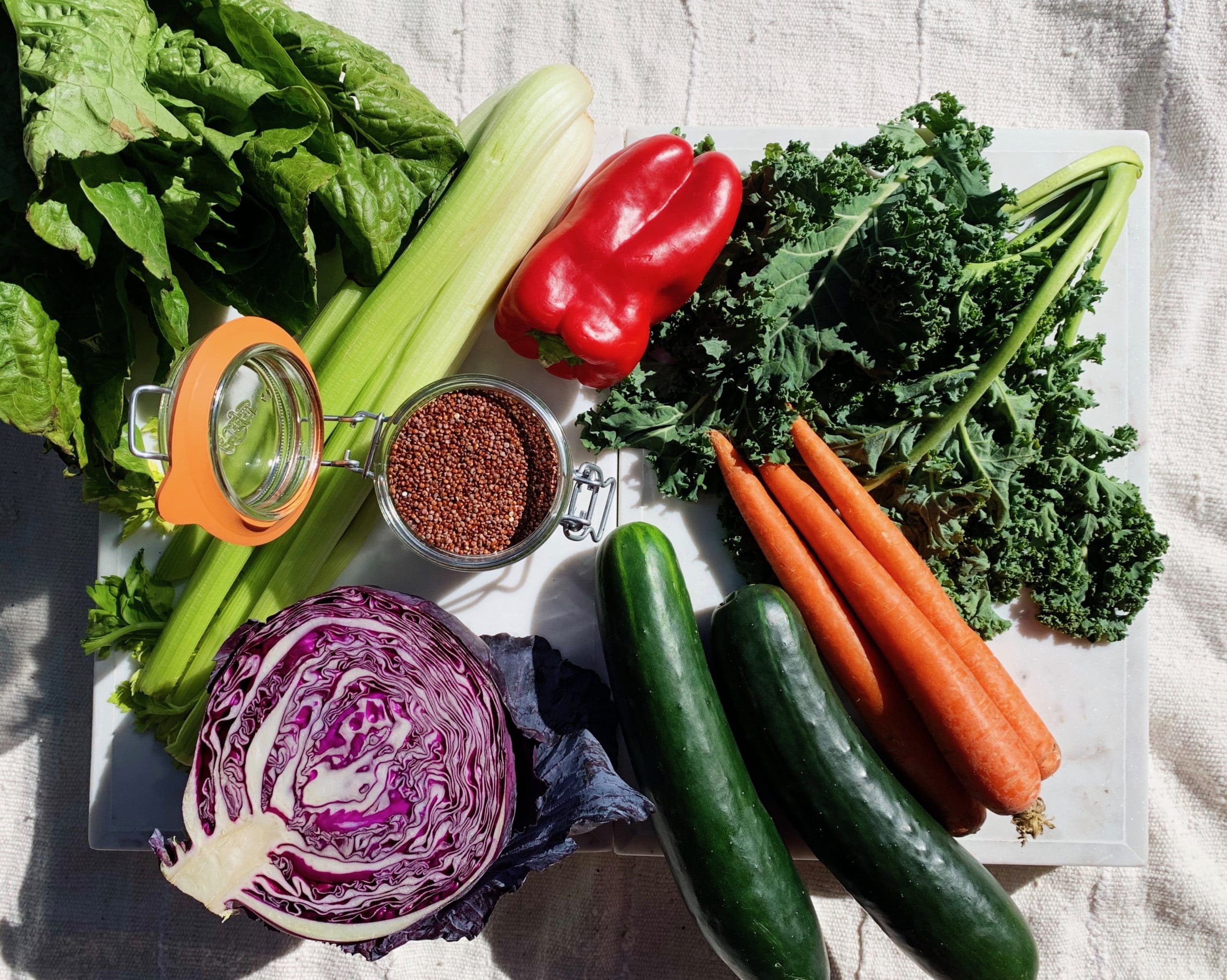variety of fresh veggies including cucumbers, carrots, kale and raddichio