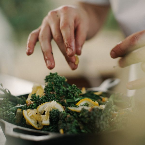 someone hand-tossing a salad