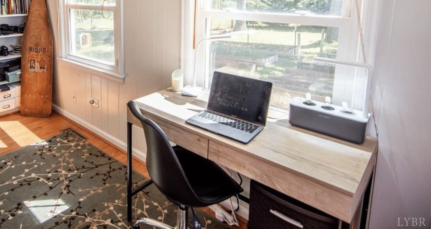 home office with a wooden desk and laptop