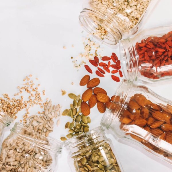 Variety of nuts and seeds in glass jars