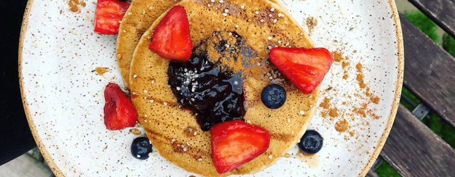 Banana pancakes with blueberries and strawberries