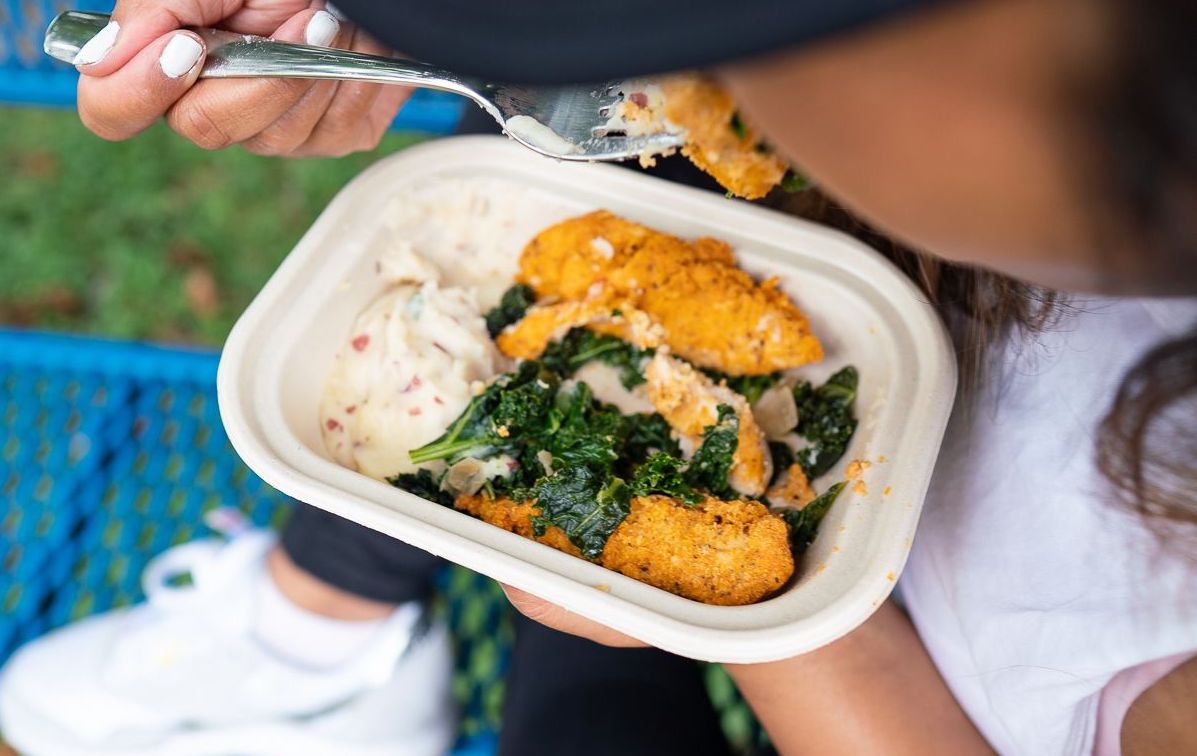 Close up of someone eating Snap Kitchen's chicken tender turnip mash