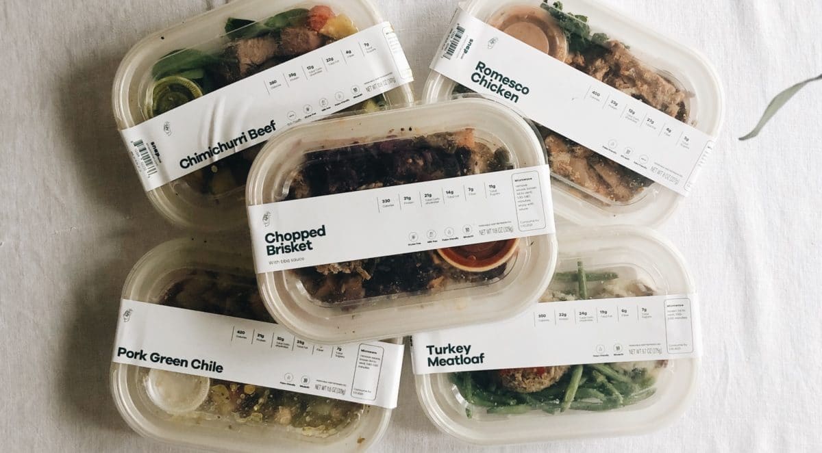 5 Snap Kitchen meals on a white background - chimichurri beef, romesco chicken, chopped brisket, pork green chile and turkey meatloaf
