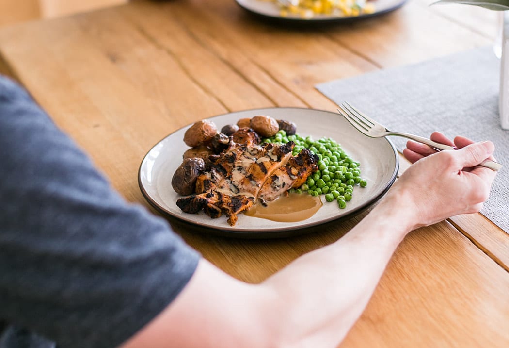 Plate with chicken, peas and potatoes and a gravy sauce