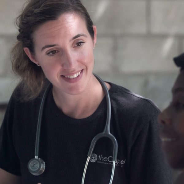 Female doctor with dark hair and a stethoscope around her neck