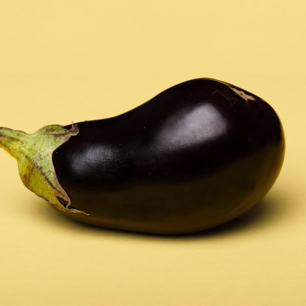 Eggplant on a pale yellow background