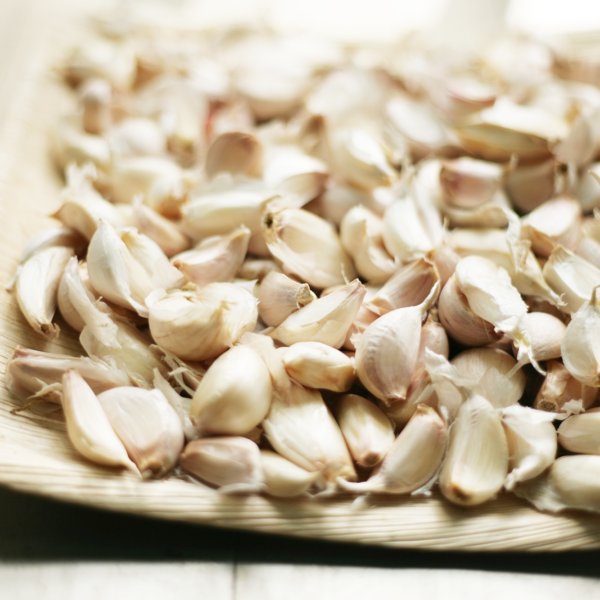 Close up of raw garlic cloves on a tray