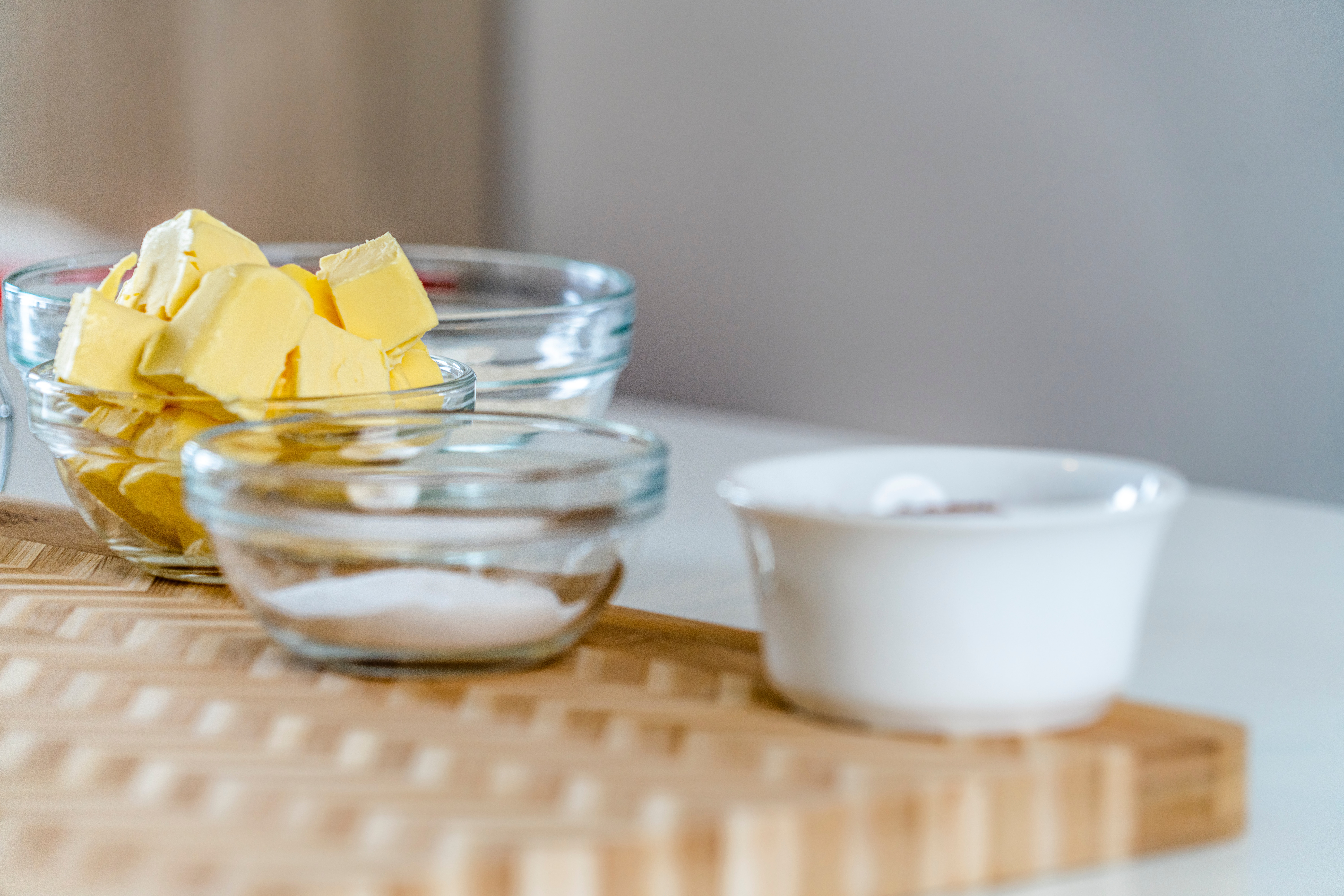 Glass bowls with butter and sugar on a cutting board