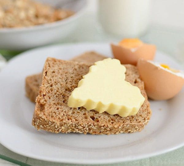 Slice of wheat bread with a pat of butter in the shape of a heart