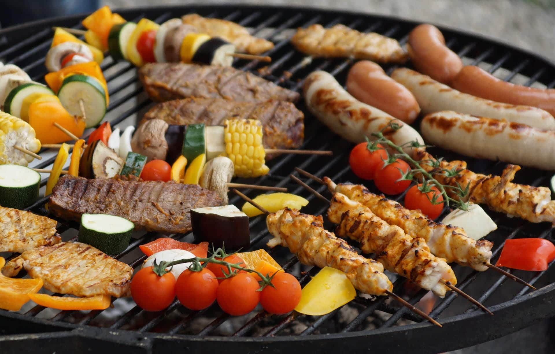 Meat and vegetables cooking on a grill