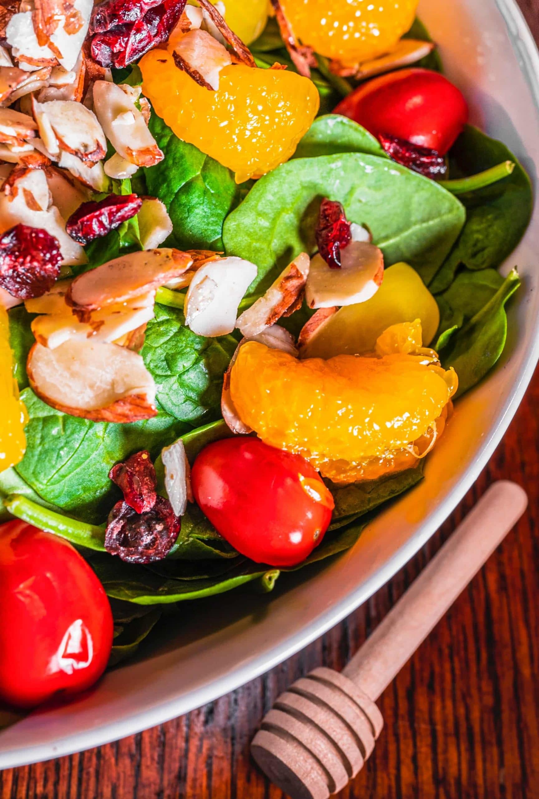 spinach salad with mandarins, dried cranberries, and other toppings