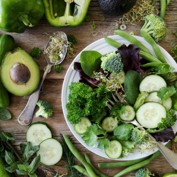 leafy green vegetables on a wooden tray