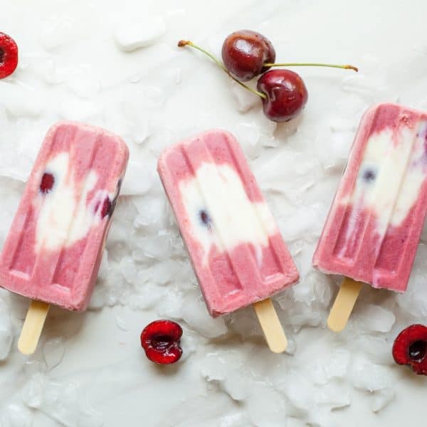 pink and white popsicles with cherries