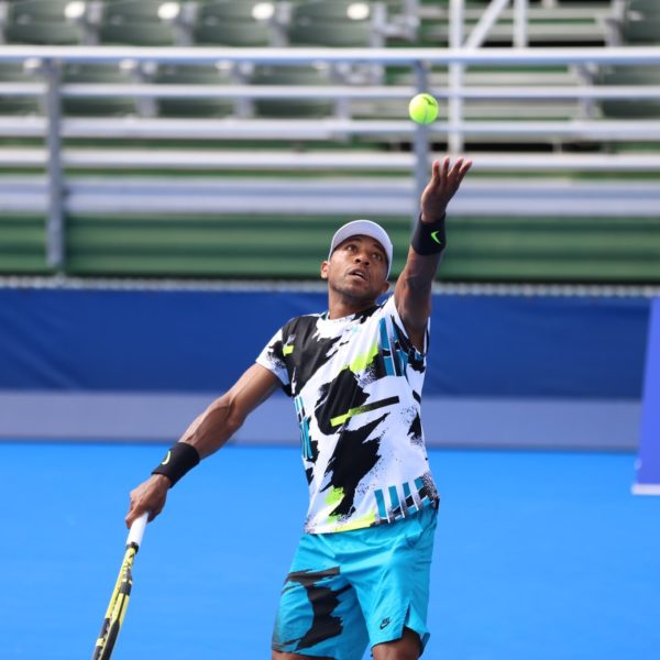 Professional tennis player Nicholas Monroe serving the ball