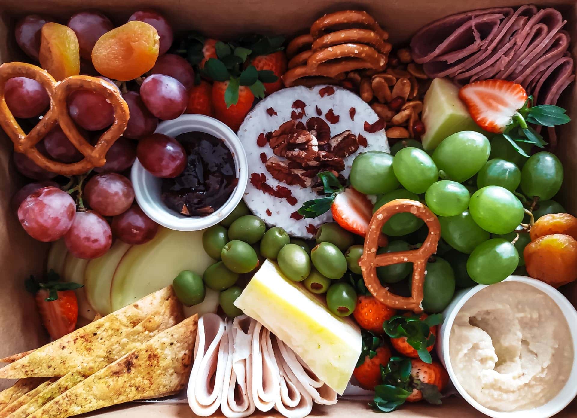 Various snacks such as cheese, grapes, pretzels, and more
